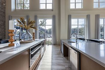 A large kitchen with large windows and a large counter top